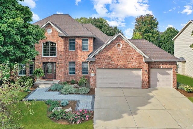 view of property featuring a garage and a front yard