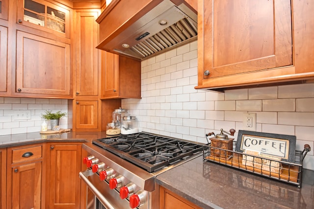 kitchen with tasteful backsplash, custom range hood, and high end range