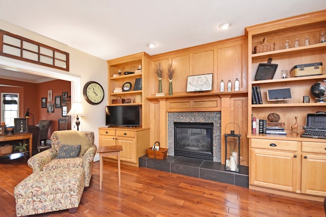 living room with a fireplace and dark hardwood / wood-style flooring