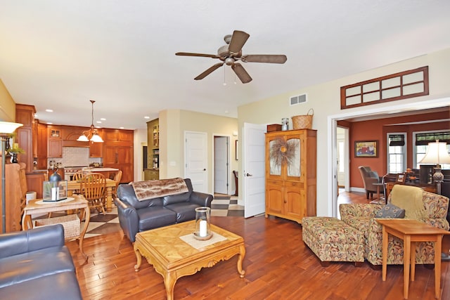 living room featuring dark hardwood / wood-style flooring and ceiling fan