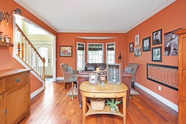 dining room with ornamental molding and hardwood / wood-style floors