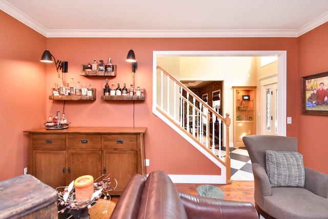 bar with light hardwood / wood-style flooring and crown molding