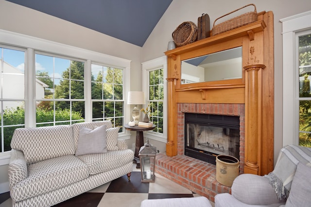 sunroom / solarium featuring lofted ceiling and a fireplace