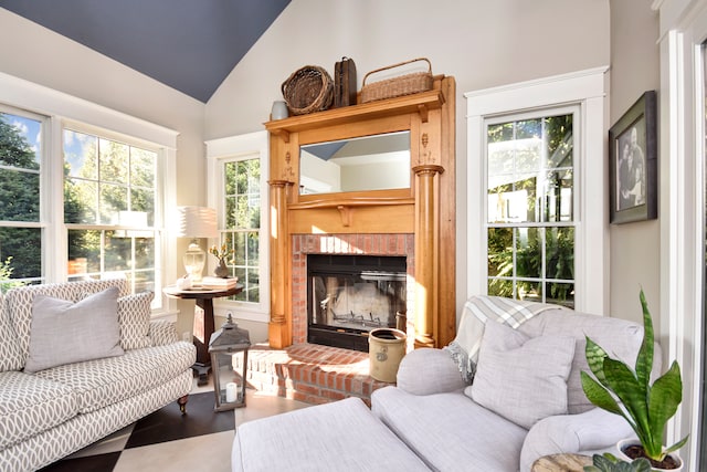 sunroom / solarium featuring a fireplace, plenty of natural light, and vaulted ceiling