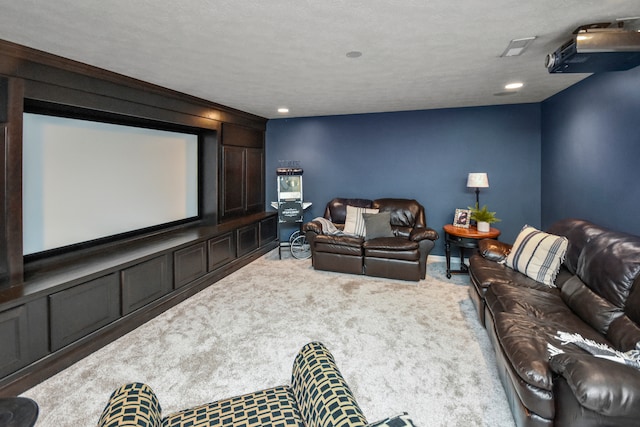 carpeted home theater room featuring a textured ceiling