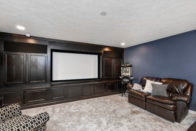 carpeted home theater room featuring a textured ceiling