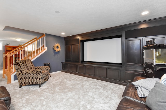 carpeted cinema room with a textured ceiling