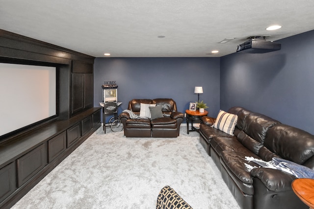 carpeted cinema featuring a textured ceiling