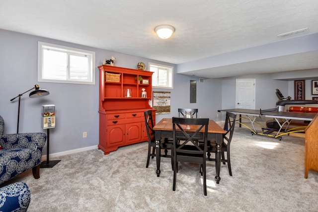 carpeted dining area featuring a wealth of natural light and a textured ceiling