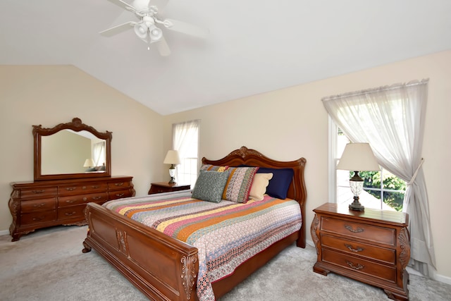 bedroom with vaulted ceiling, light colored carpet, and ceiling fan