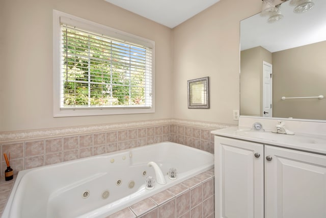 bathroom featuring tiled bath and vanity