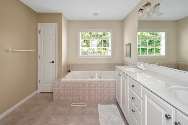 bathroom with vanity, a wealth of natural light, and tile patterned flooring