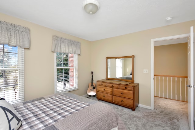 carpeted bedroom featuring multiple windows