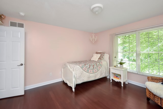 bedroom with dark hardwood / wood-style flooring