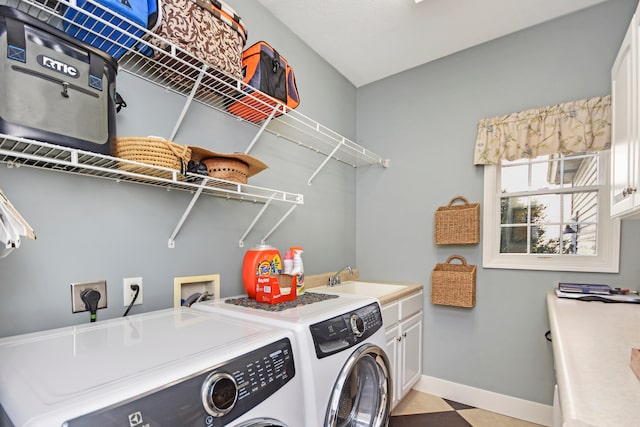 laundry room featuring cabinets, sink, and independent washer and dryer