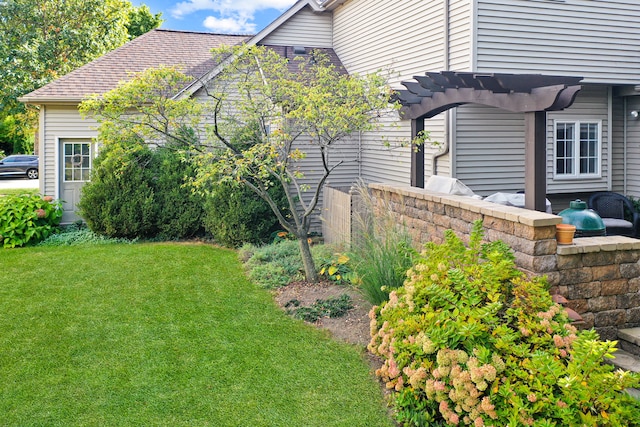 view of home's exterior with a pergola and a lawn