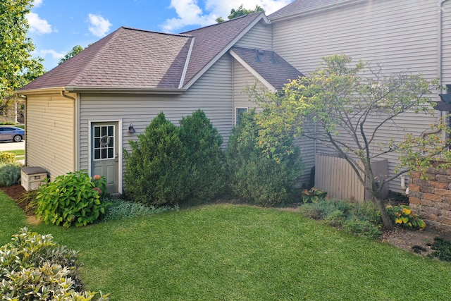 view of side of home with a lawn