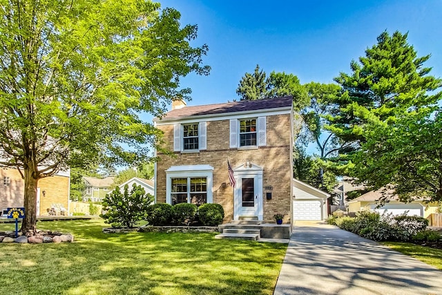 colonial-style house featuring a garage and a front yard