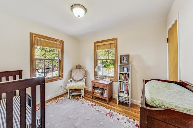 bedroom featuring hardwood / wood-style floors and multiple windows