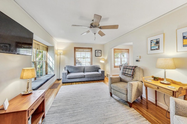 living room featuring ceiling fan and light wood-type flooring