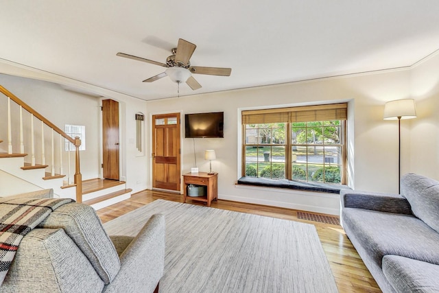 living room with light hardwood / wood-style floors and ceiling fan