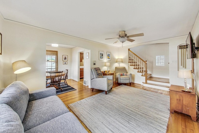 living room featuring ceiling fan and hardwood / wood-style floors