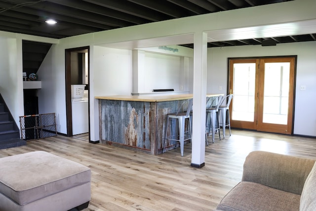 interior space with light wood-type flooring and beam ceiling