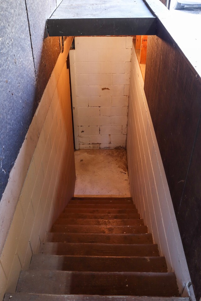 stairs with wood-type flooring