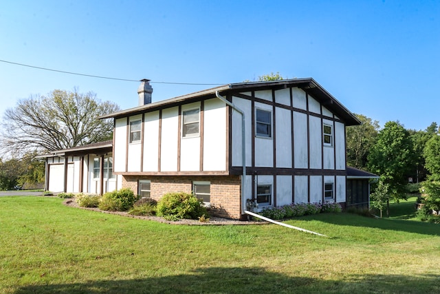 view of side of home with a lawn and a garage