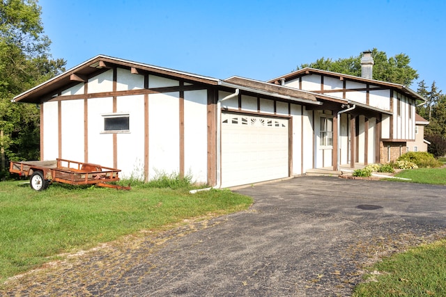 exterior space featuring a garage and a lawn