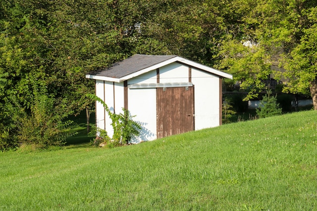 view of outbuilding with a lawn