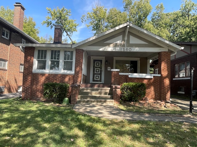 view of front of property with a porch and a front yard