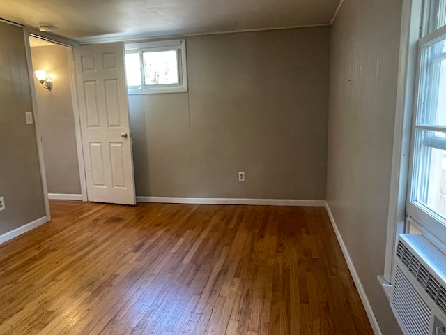 interior space featuring wood-type flooring and crown molding