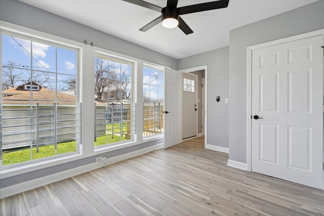 foyer entrance with light hardwood / wood-style flooring and ceiling fan