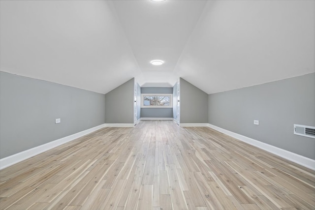 bonus room featuring light wood-type flooring and lofted ceiling