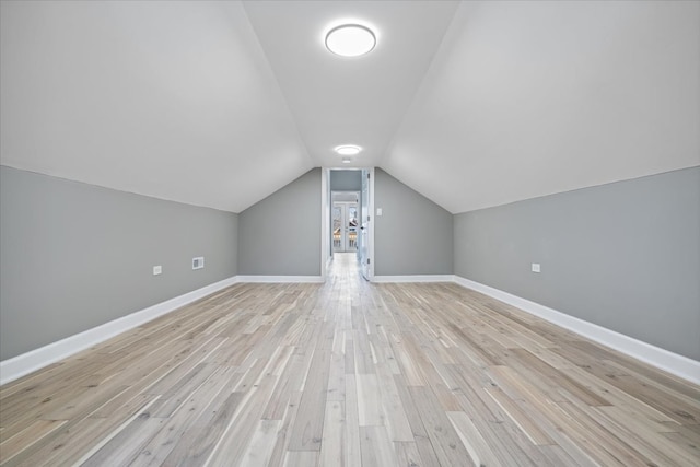 bonus room with light hardwood / wood-style flooring and lofted ceiling