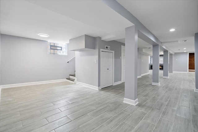 basement with light hardwood / wood-style flooring