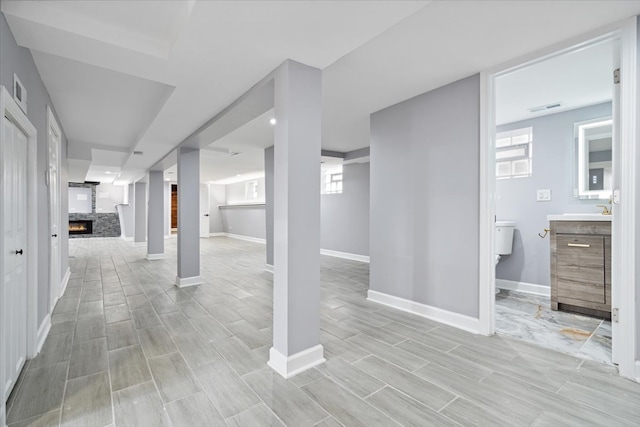 basement featuring a healthy amount of sunlight and light hardwood / wood-style floors