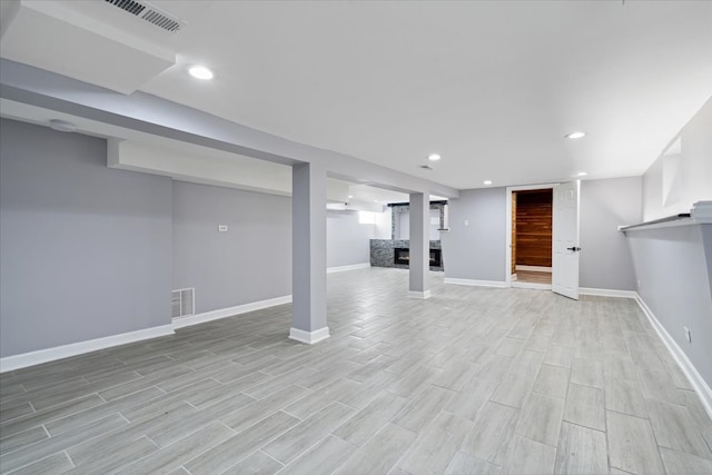 basement with light hardwood / wood-style flooring