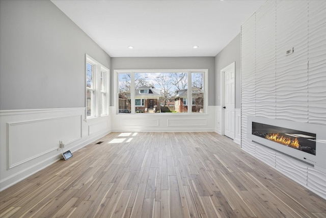 unfurnished living room featuring light wood-type flooring