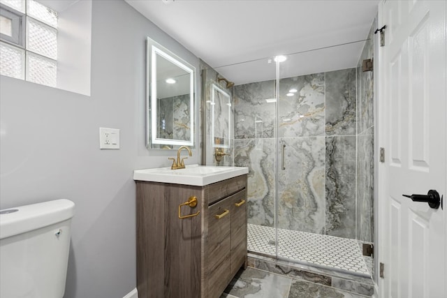 bathroom with vanity, toilet, and an enclosed shower