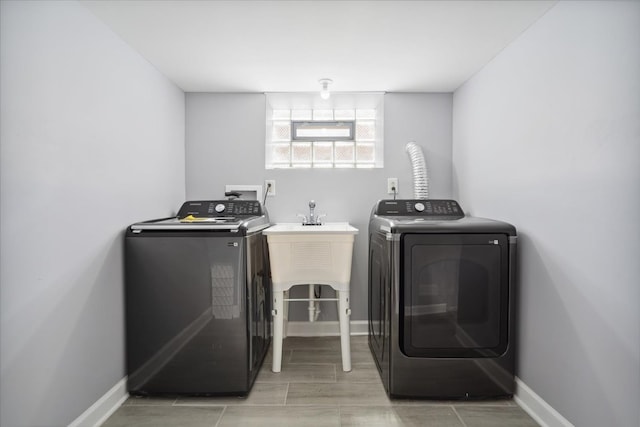 clothes washing area featuring separate washer and dryer and hardwood / wood-style flooring