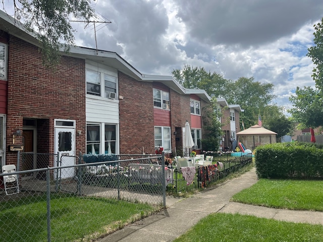 view of property's community with a lawn