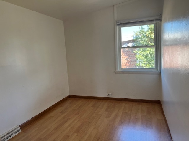 spare room with light hardwood / wood-style floors