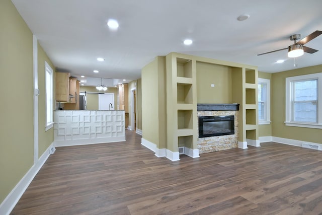 340 Pine St, Joliet, IL 60435 - unfurnished living room featuring visible vents, a fireplace, dark wood-type flooring, and a ceiling fan