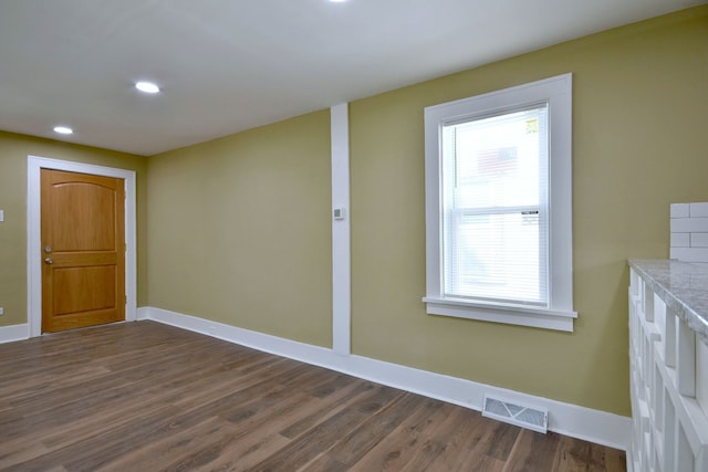 unfurnished room with dark hardwood / wood-style floors