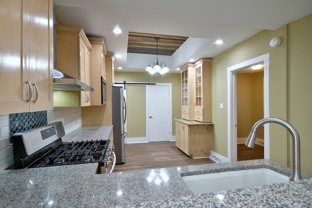 340 Pine St, Joliet, IL 60435 - kitchen with tasteful backsplash, light brown cabinetry, exhaust hood, stainless steel appliances, and a sink