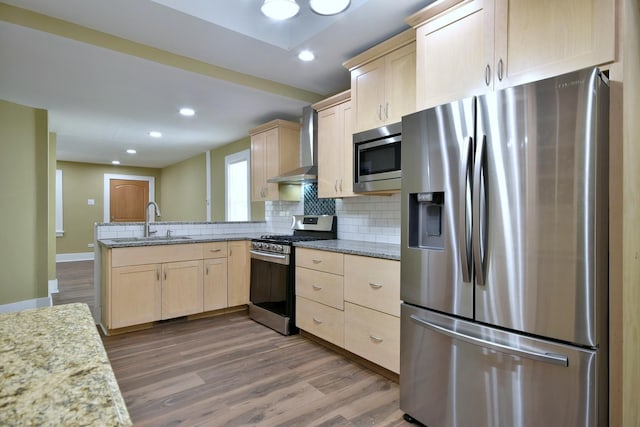 340 Pine St, Joliet, IL 60435 - kitchen featuring light brown cabinets, a sink, appliances with stainless steel finishes, a peninsula, and wall chimney range hood