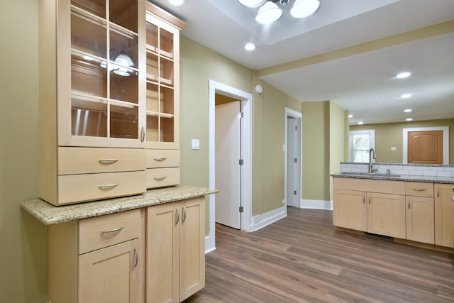 kitchen featuring sink, light brown cabinets, dark hardwood / wood-style flooring, and tasteful backsplash