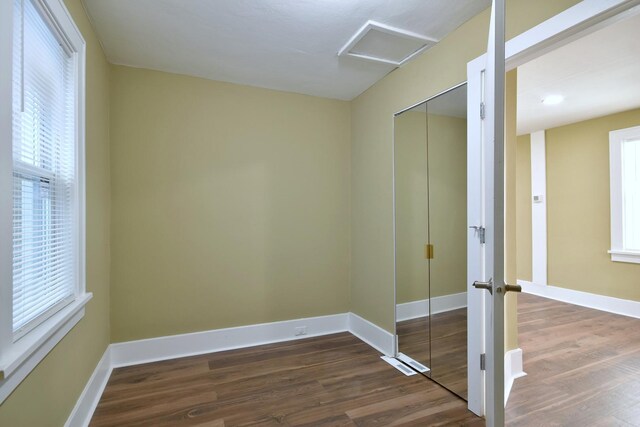 340 Pine St, Joliet, IL 60435 - unfurnished bedroom featuring a closet, baseboards, attic access, and dark wood finished floors